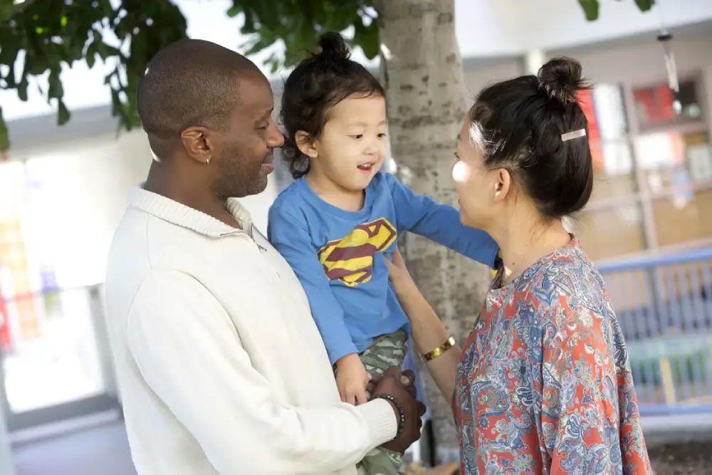 A warm, positive image of a divorced couple co parenting